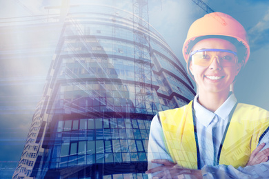 Image of Double exposure of female industrial engineer in uniform and building