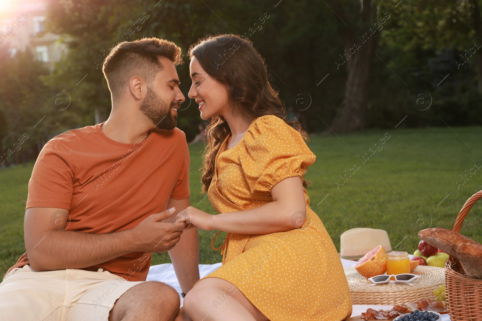 Photo of Lovely couple having picnic in park on sunny day