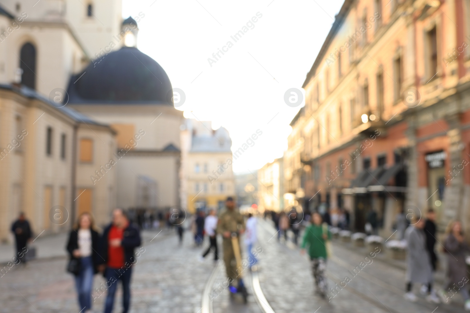 Photo of Blurred view of people walking on city street