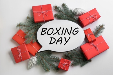 Photo of Speech bubble with phrase BOXING DAY and Christmas decorations on white background, flat lay