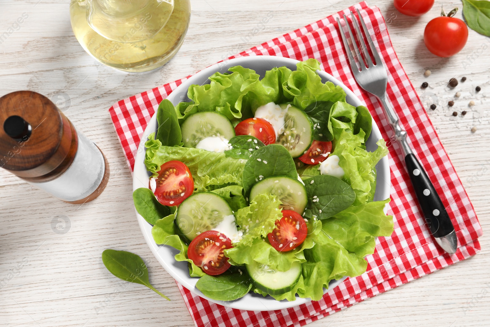 Photo of Delicious salad served on white wooden table, flat lay