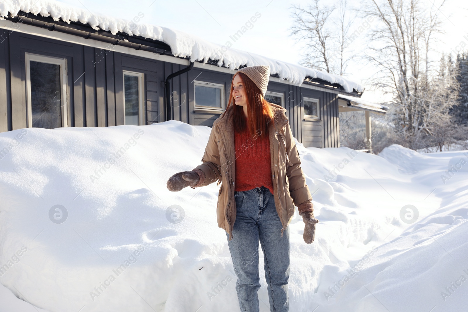 Photo of Portrait of beautiful young woman on snowy day outdoors. Winter vacation