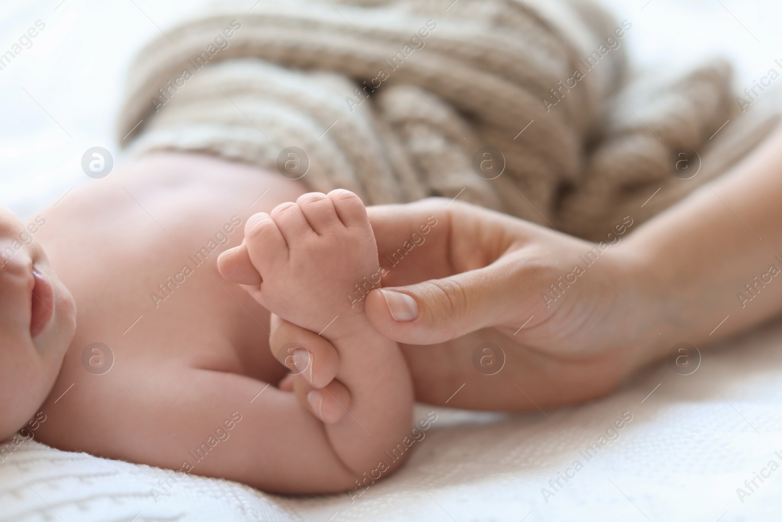 Photo of Young mother with her newborn baby at home