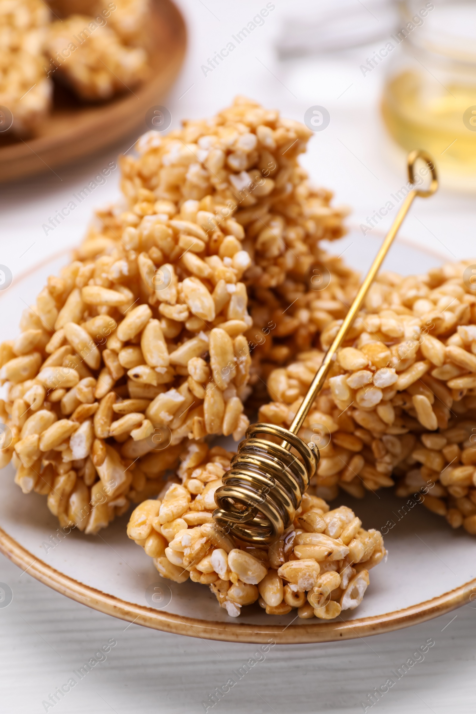 Photo of Puffed rice bars (kozinaki) on white plate, closeup