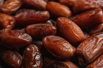 Photo of Sweet dried date fruits as background, closeup