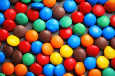 Photo of Many colorful candies as background, top view