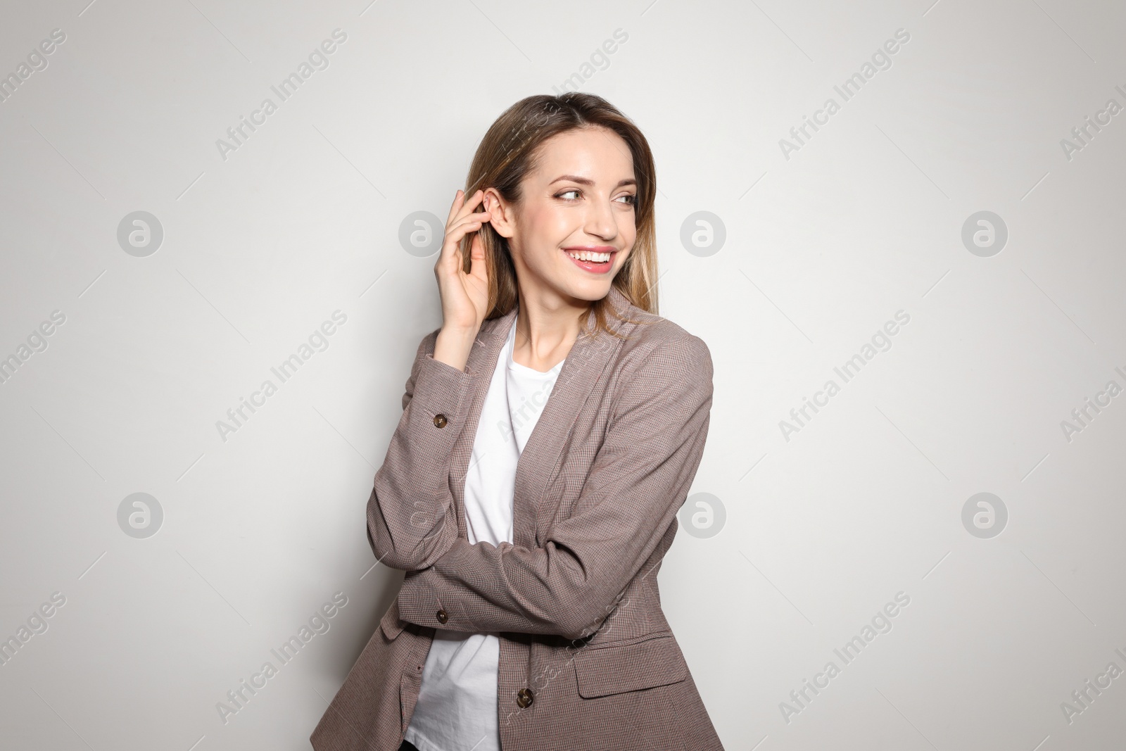 Photo of Portrait of young woman with beautiful face on light background