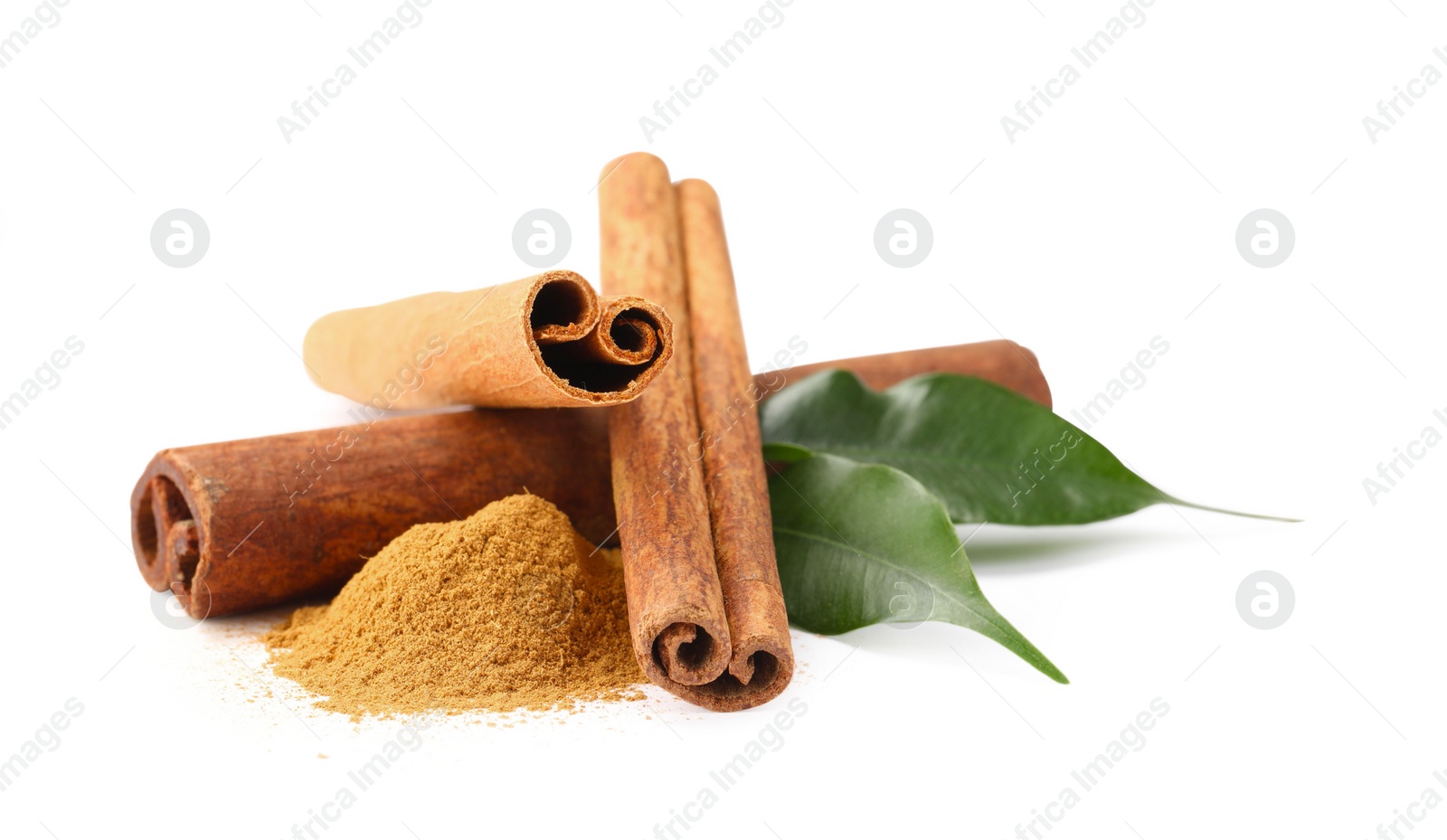 Photo of Dry aromatic cinnamon sticks, powder and green leaves isolated on white