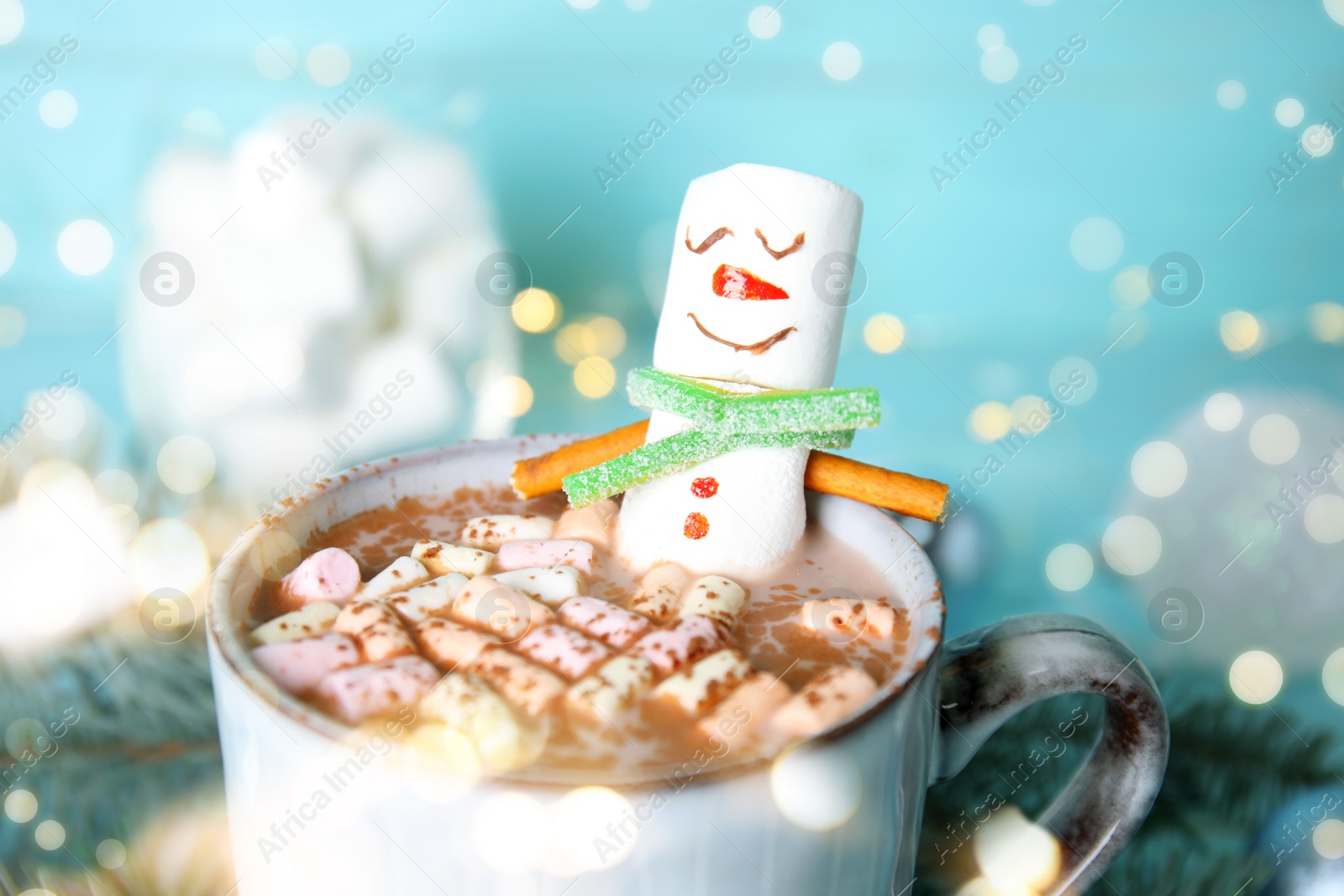 Image of Funny marshmallow snowman in cup with hot drink, closeup. Bokeh effect 