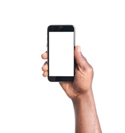 Photo of African-American man holding mobile phone with blank screen in hand on white background
