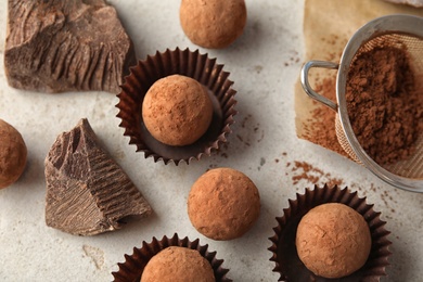 Photo of Flat lay composition with tasty raw chocolate truffles on light background