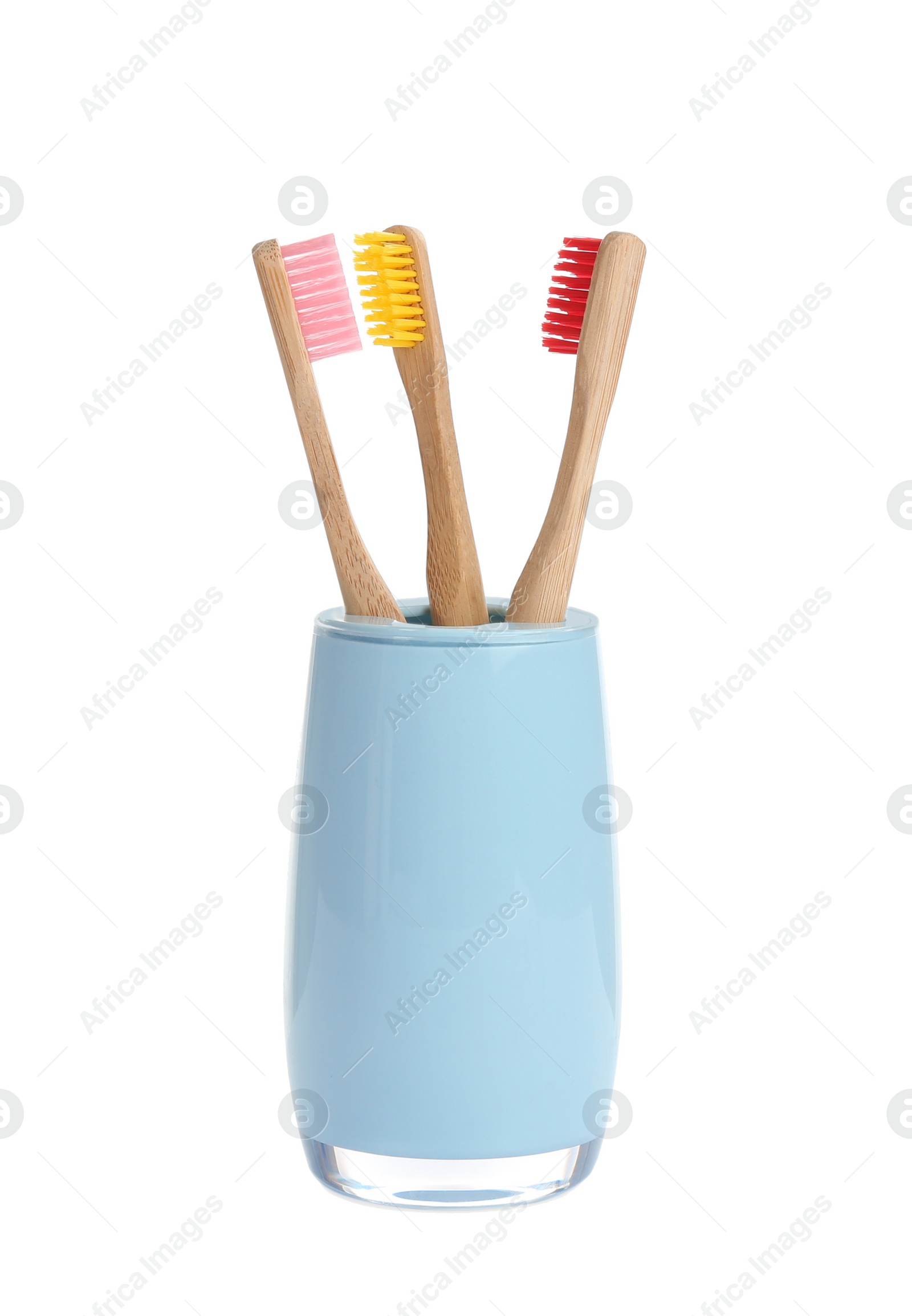 Photo of Bamboo toothbrushes in holder isolated on white