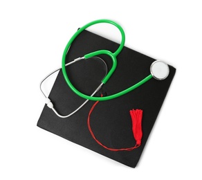 Photo of Stethoscope and graduation hat on white background, top view. Medical students stuff