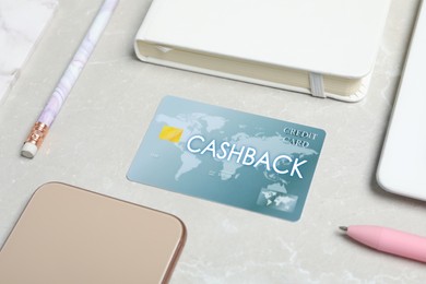 Image of Composition with cashback credit card and stationery on light grey marble background