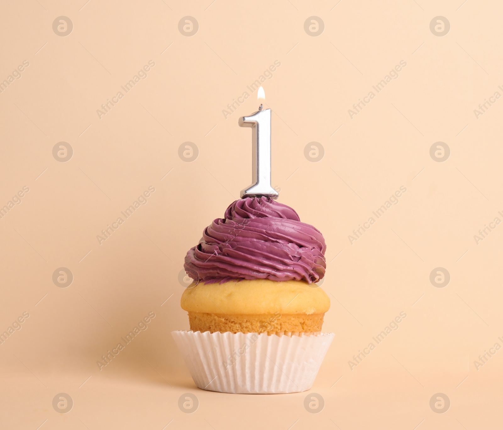 Photo of Birthday cupcake with number one candle on beige background