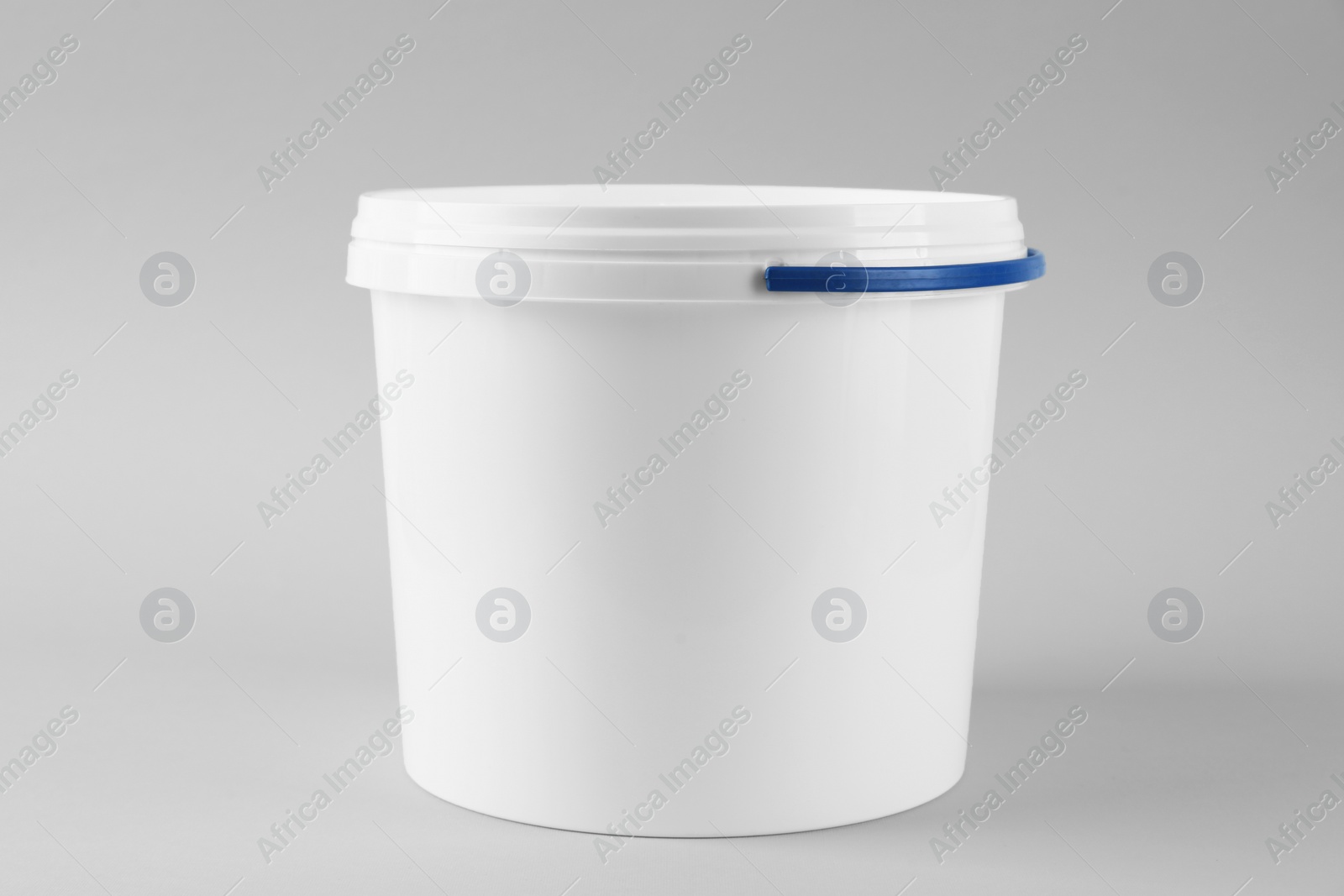 Photo of One plastic bucket with lid on white background