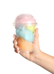 Photo of Young woman holding plastic cup with cotton candy on white background, closeup