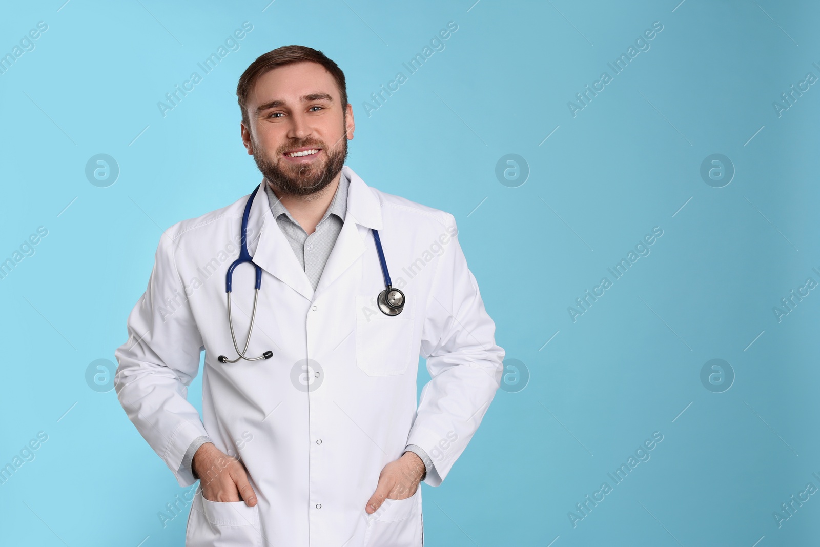 Photo of Pediatrician with stethoscope on light blue background, space for text