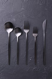 Photo of Beautiful cutlery set on black table, flat lay