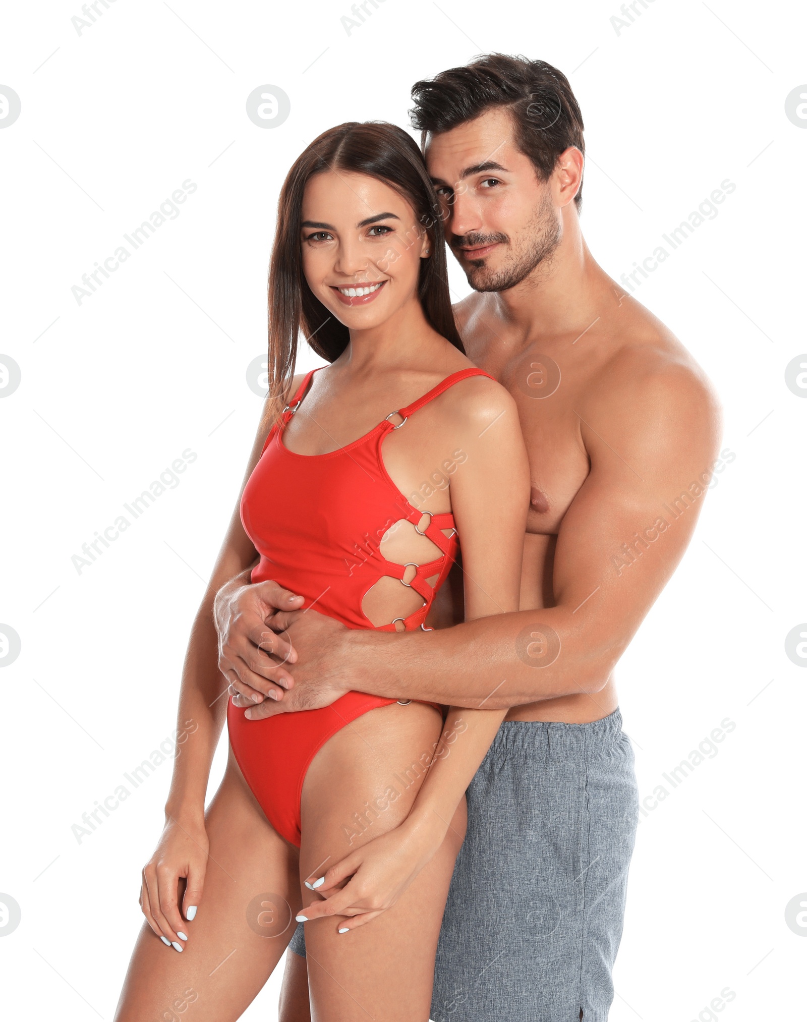 Photo of Young attractive couple in beachwear on white background