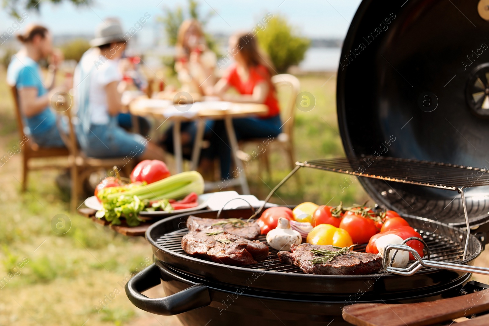 Photo of Modern grill with meat and vegetables outdoors, closeup