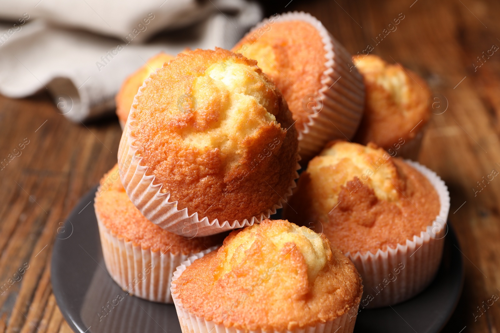 Photo of Delicious sweet muffins on wooden table, closeup