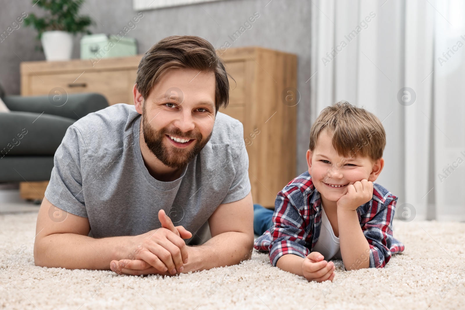 Photo of Family portrait of happy dad and son at home