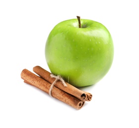 Photo of Fresh apple and cinnamon sticks on white background