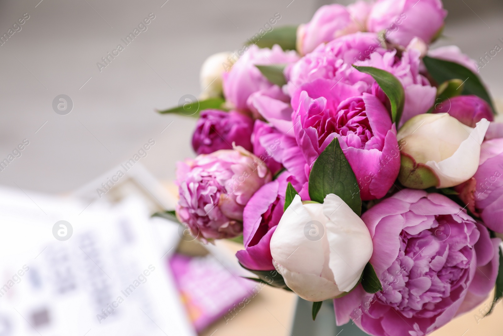 Photo of Bouquet of beautiful peonies on blurred background, closeup. Space for text