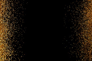 Photo of Frame made of gold glitter on black background, top view with space for text