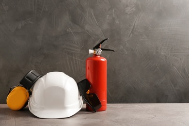 Photo of Composition with safety equipment on table against grey background. Space for text