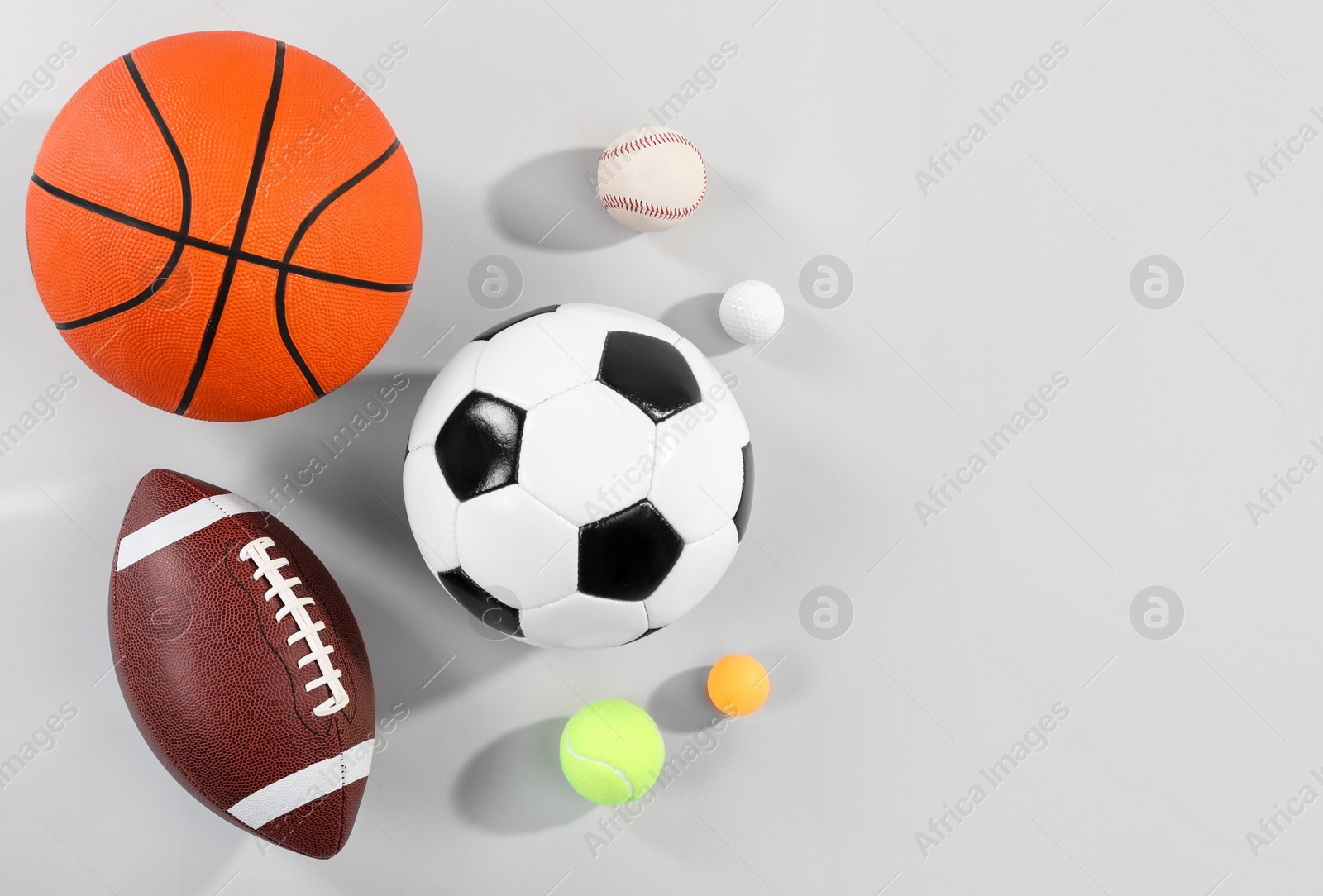 Photo of Many different sports balls on gray background, flat lay. Space for text