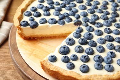 Photo of Tasty cake with blueberry on table, closeup