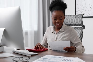 Professional accountant working at wooden desk in office