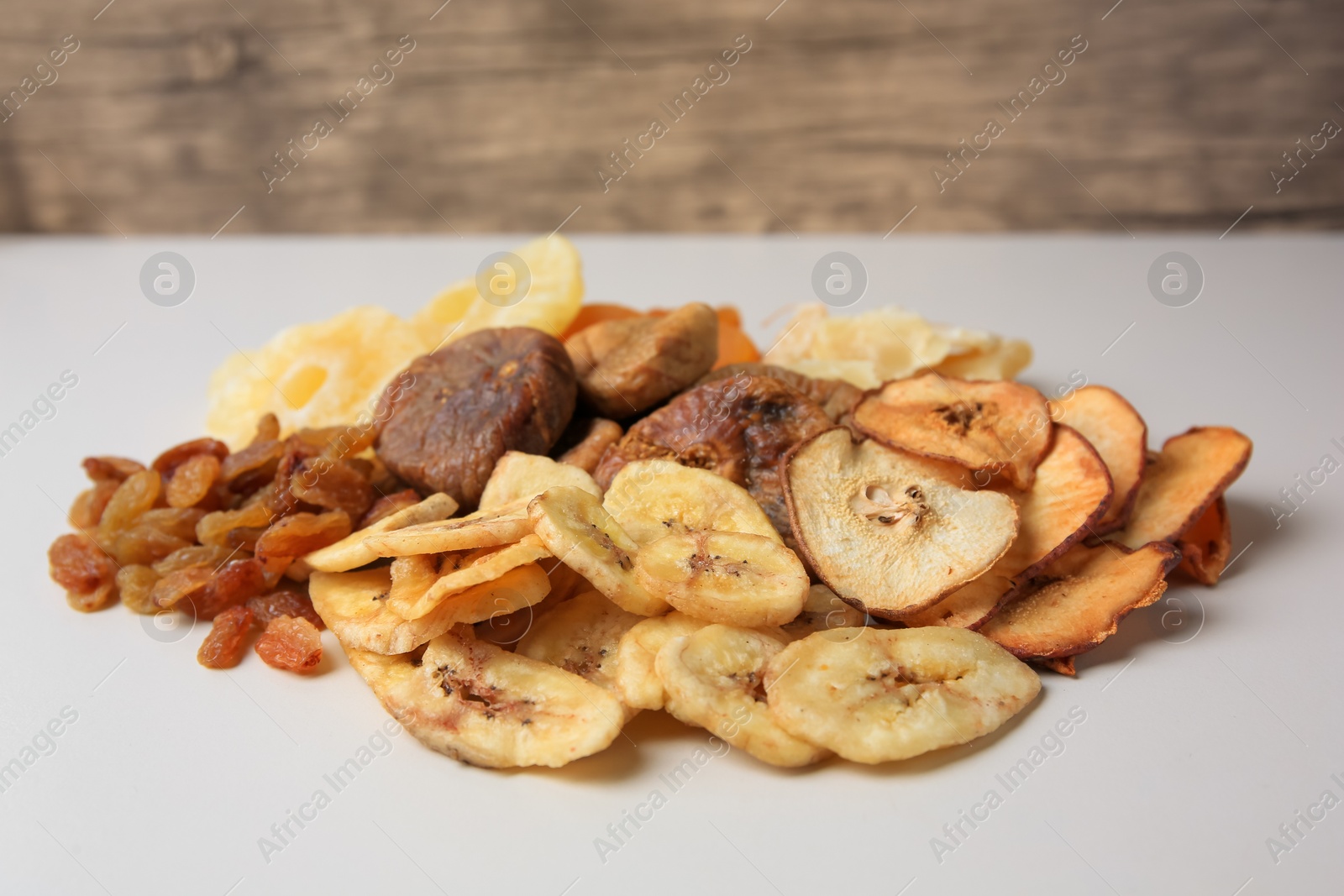 Photo of Pile of different dried fruits on white background