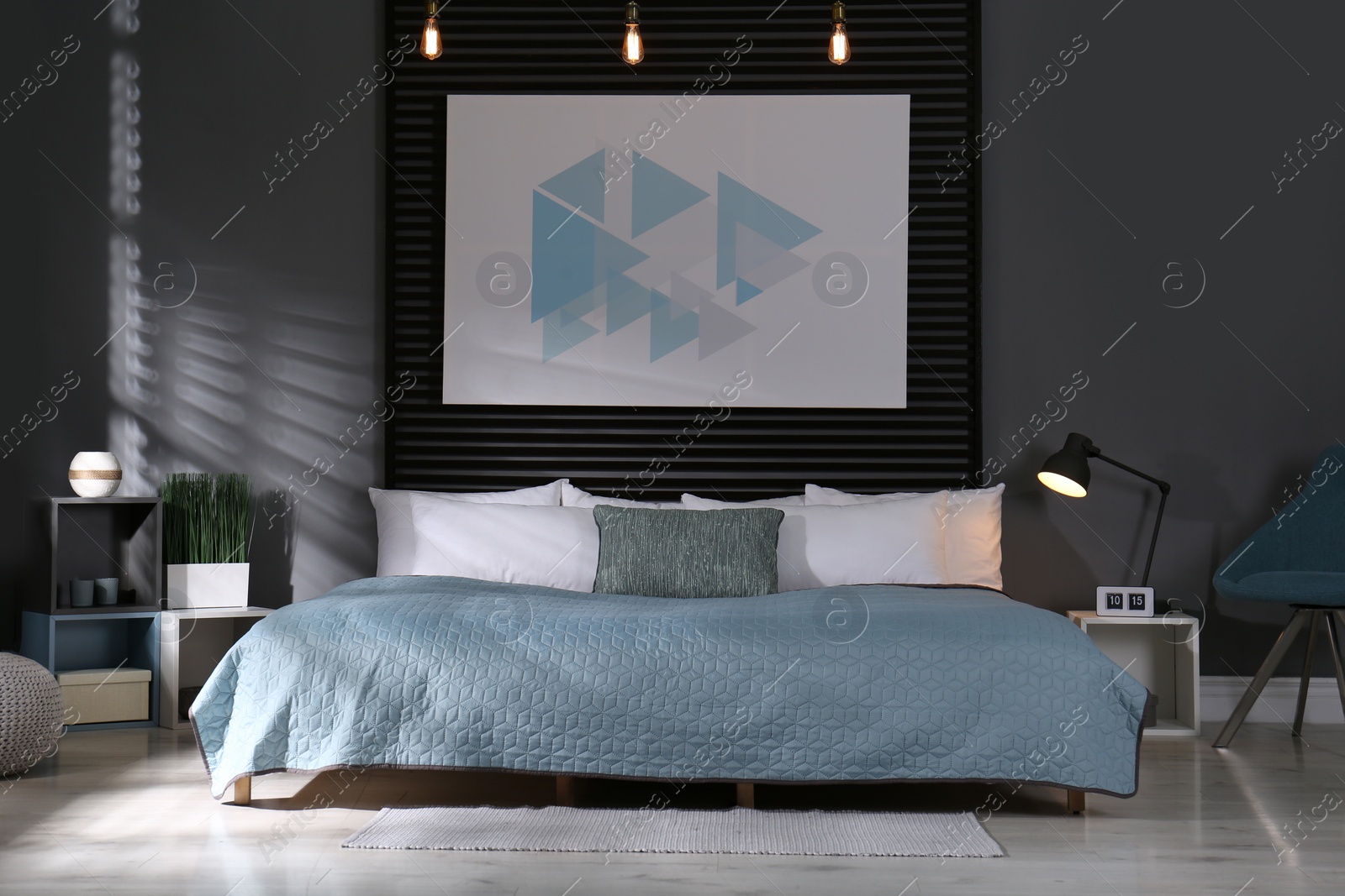 Photo of Comfortable bedroom with picture on decorative wall. Interior design