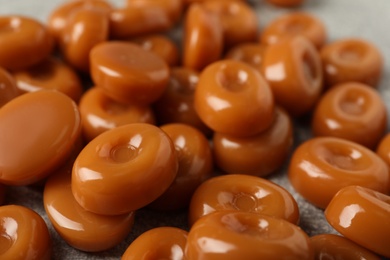 Photo of Tasty hard toffee candies on table, closeup