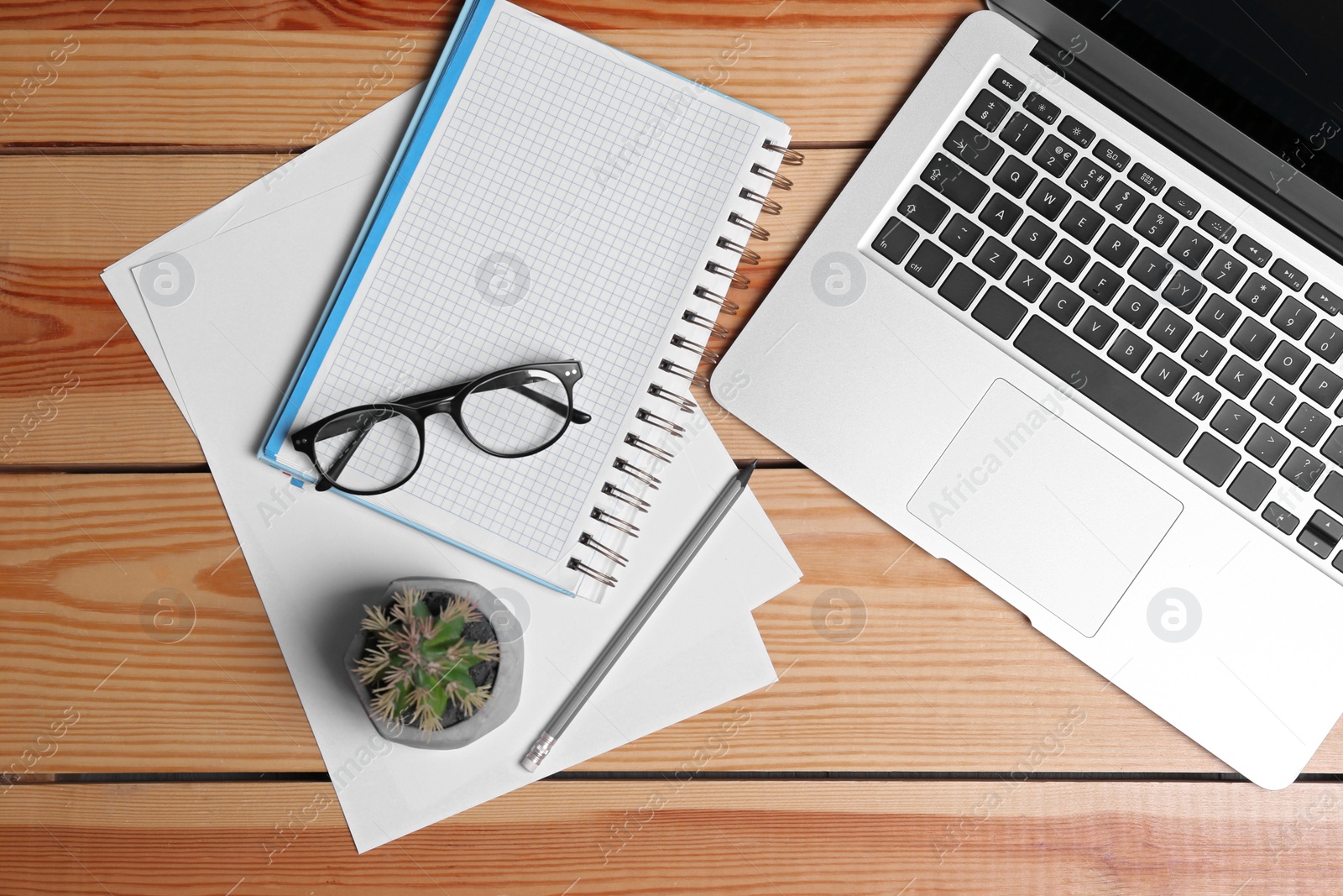 Photo of Flat lay composition with modern laptop and stationery on office table