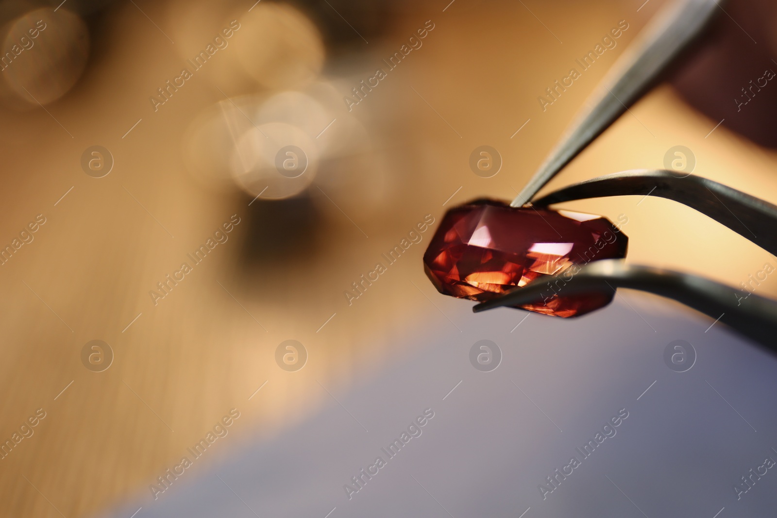 Photo of Beautiful gemstone in jeweler's workshop, closeup. Space for text