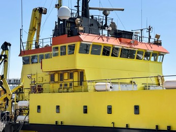 Photo of Ship moored in sea port on sunny day