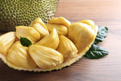 Fresh exotic jackfruit bulbs on wooden table