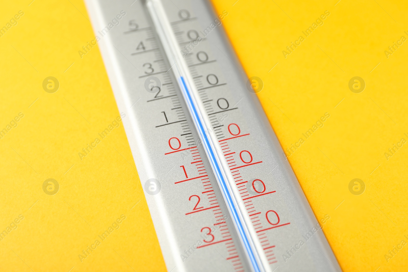 Photo of Modern weather thermometer on yellow background, closeup