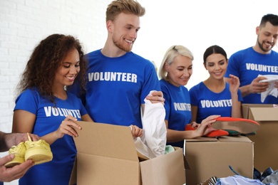 Photo of Team of volunteers collecting donations in boxes indoors