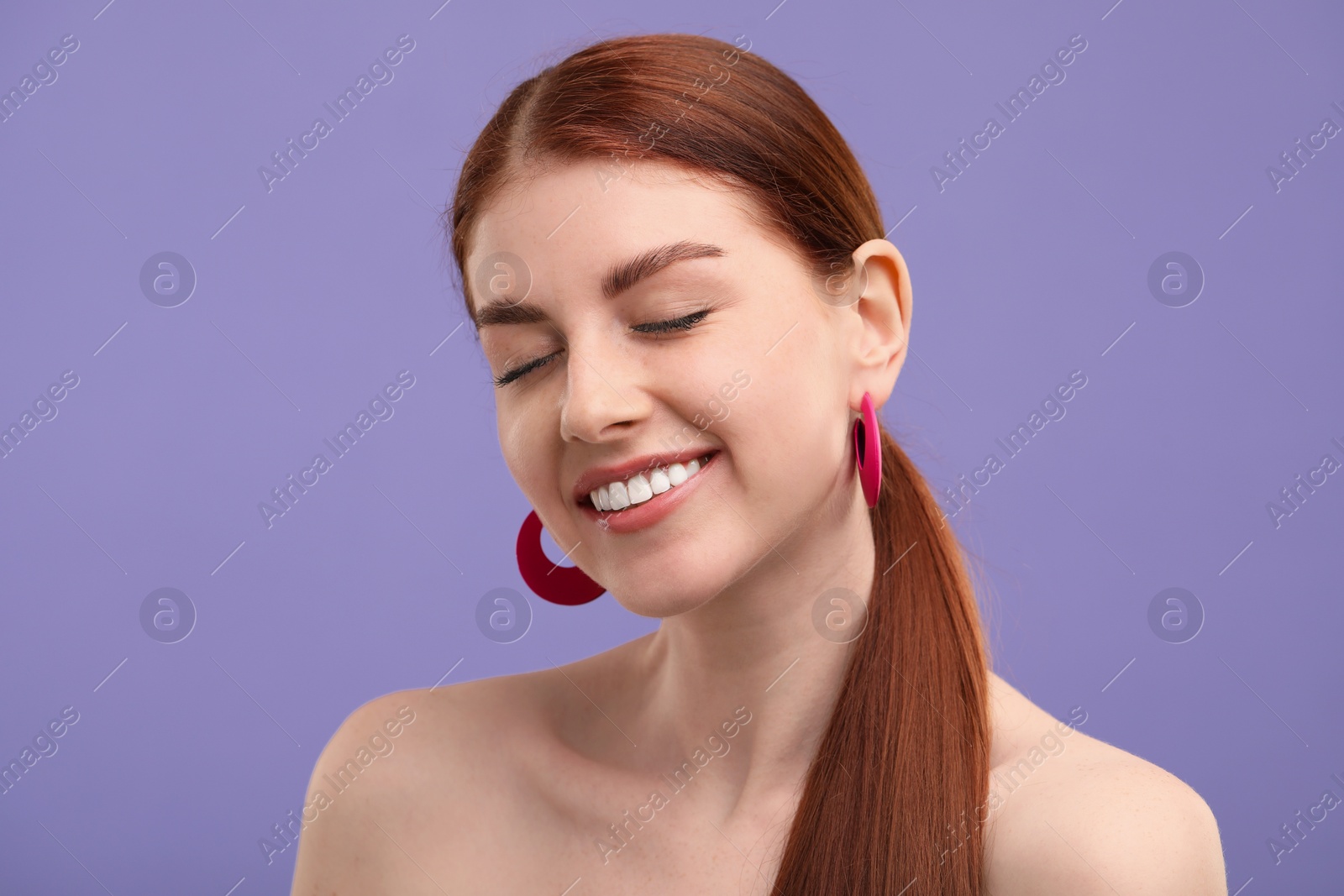 Photo of Portrait of smiling woman on purple background