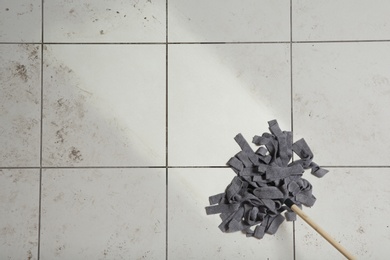 Photo of Washing of dirty floor with mop, top view. Space for text