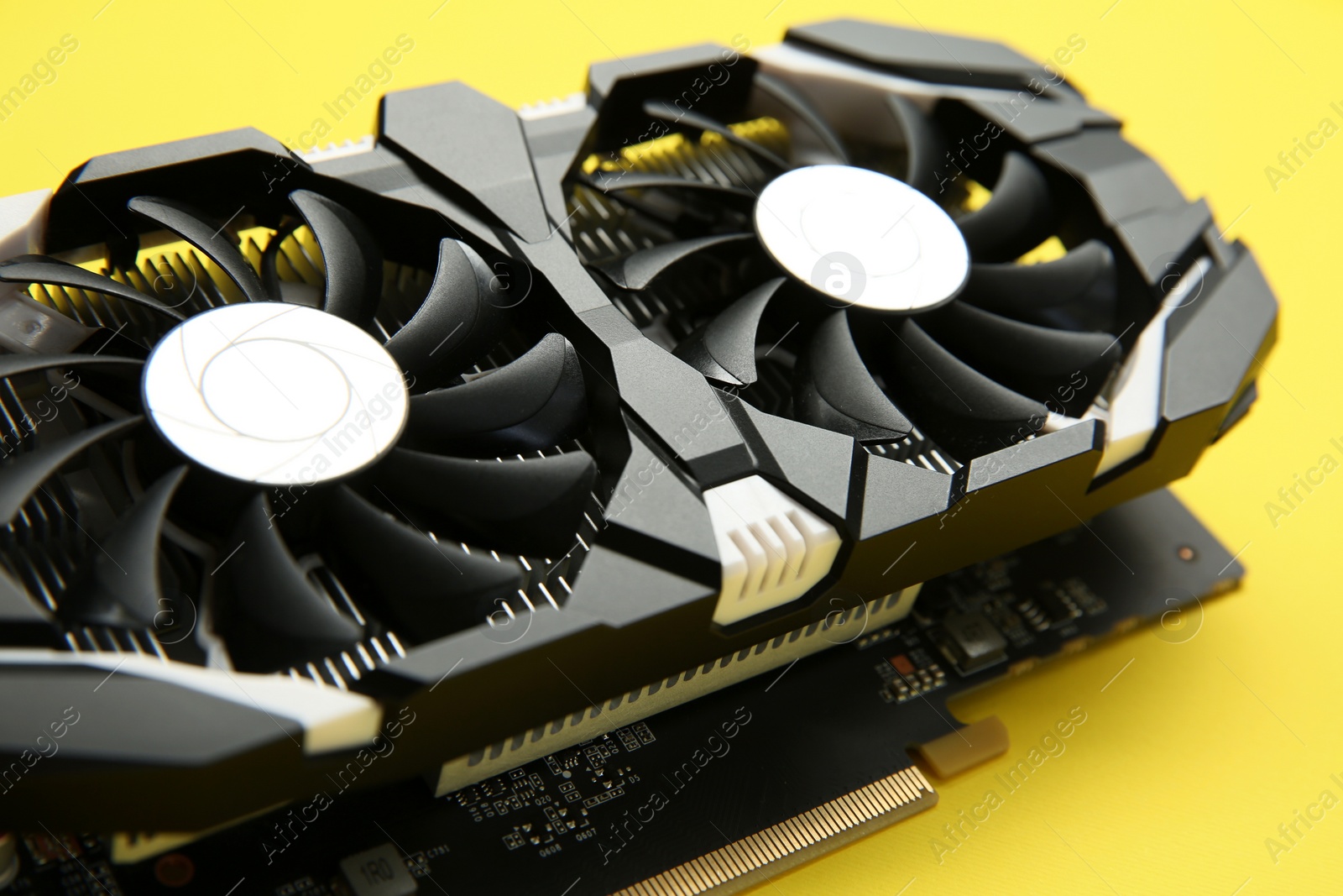 Photo of Computer graphics card on yellow background, closeup