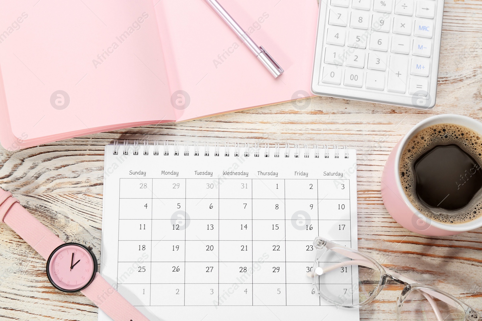 Photo of Flat lay composition with calendar and cup of coffee on white wooden table