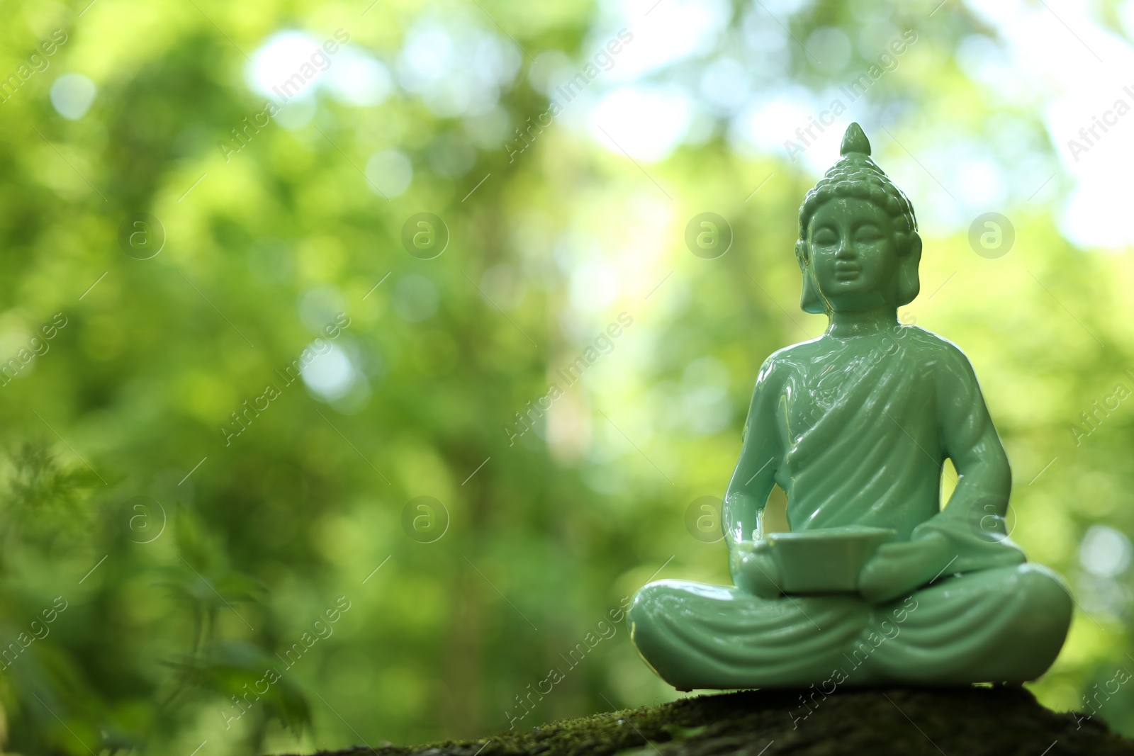 Photo of Decorative Buddha statue on blurred background. Space for text