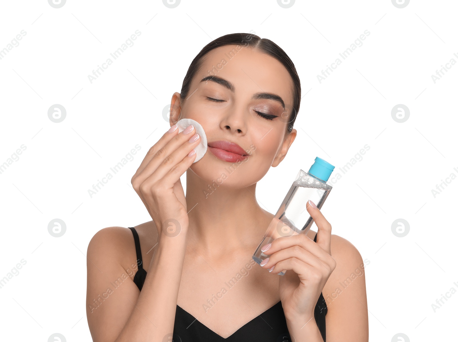 Photo of Beautiful woman removing makeup with cotton pad on white background