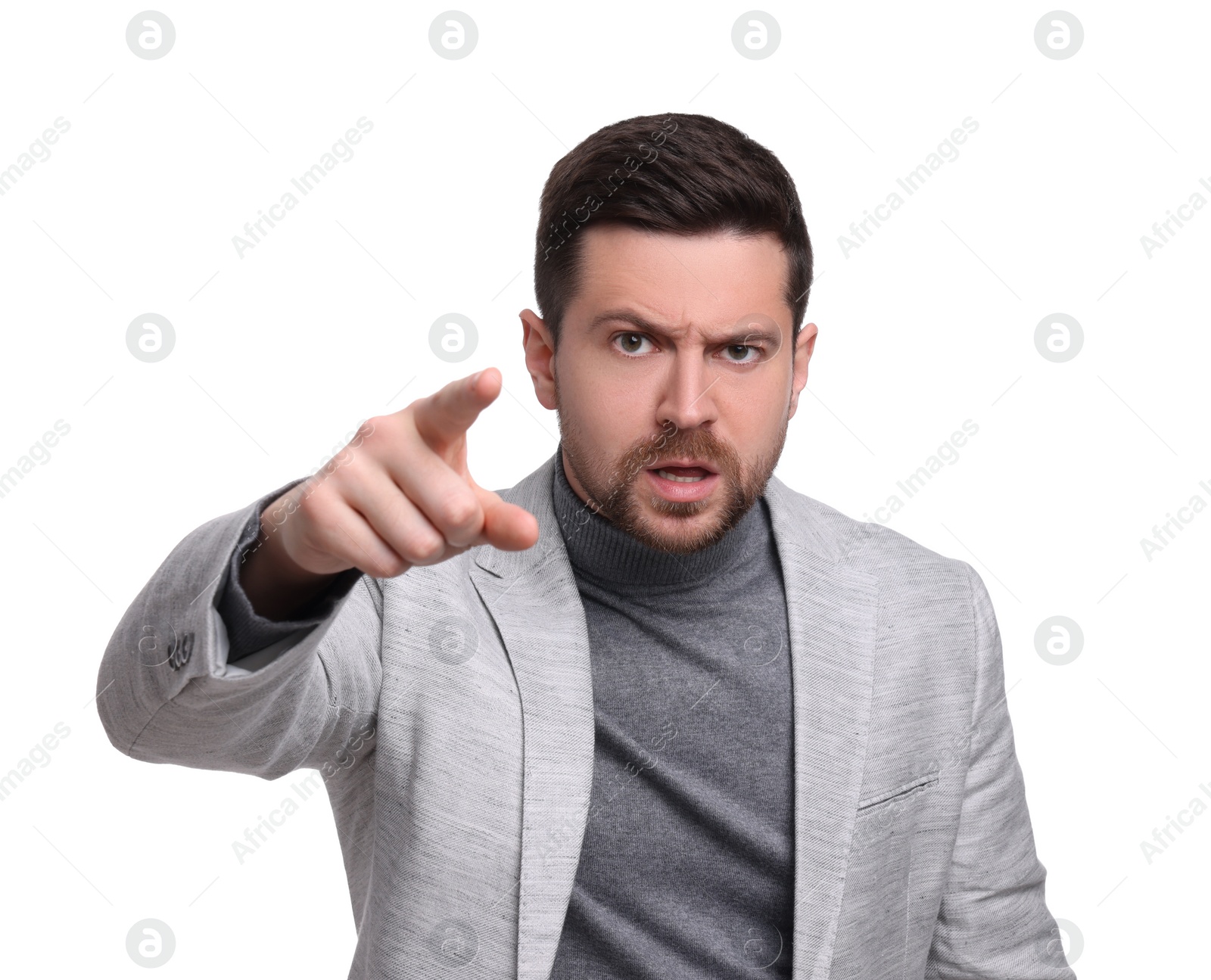 Photo of Emotional businessman in suit pointing at something on white background